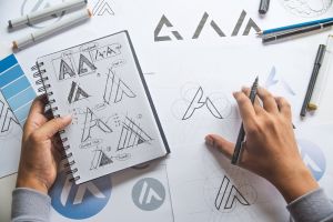 Graphic designer drafting sketches. Logo design.