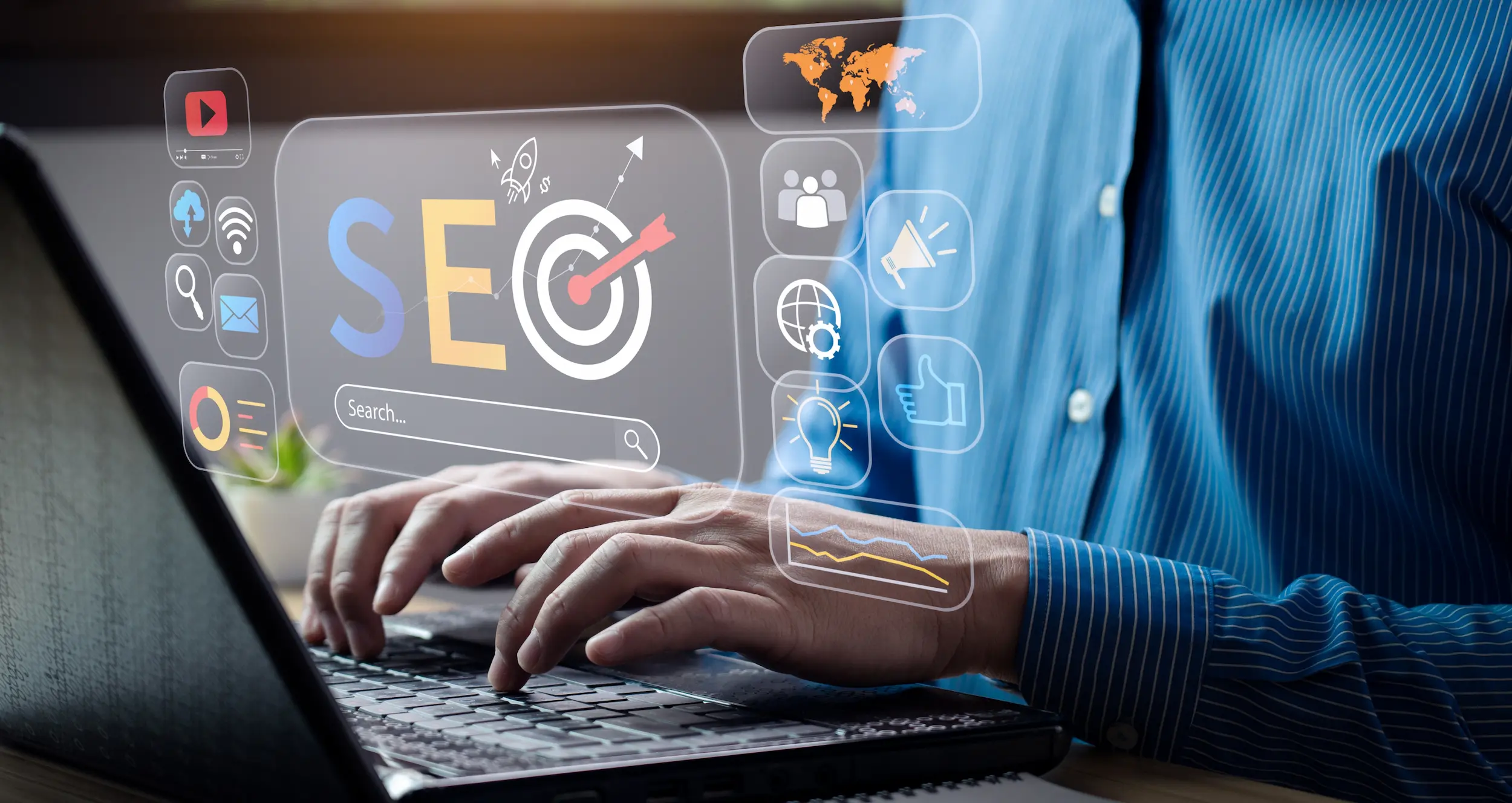 Person typing on a laptop with SEO icons and graphics in a virtual display.