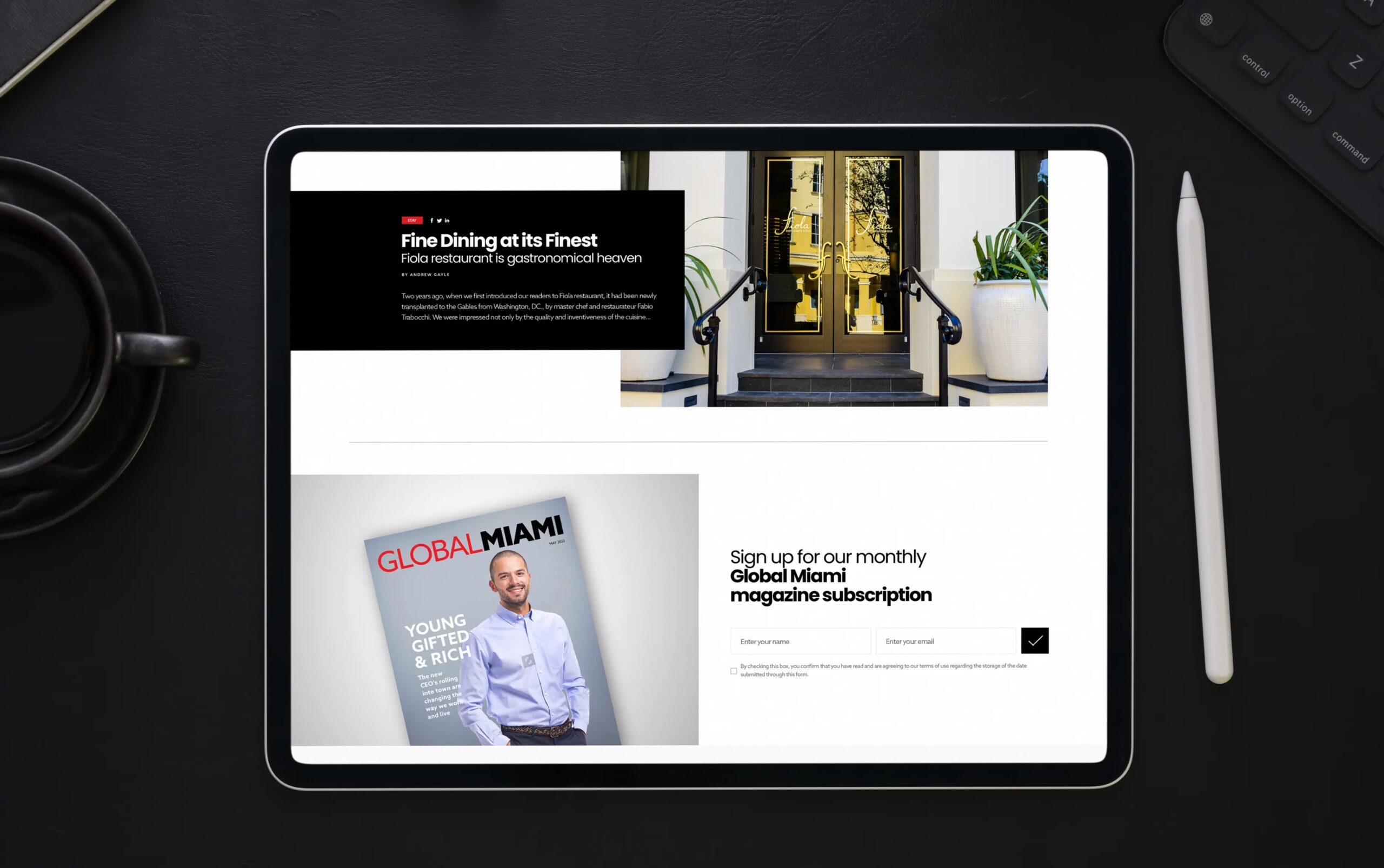 Tablet displaying a professional website with sleek design elements, including a magazine cover and subscription option.