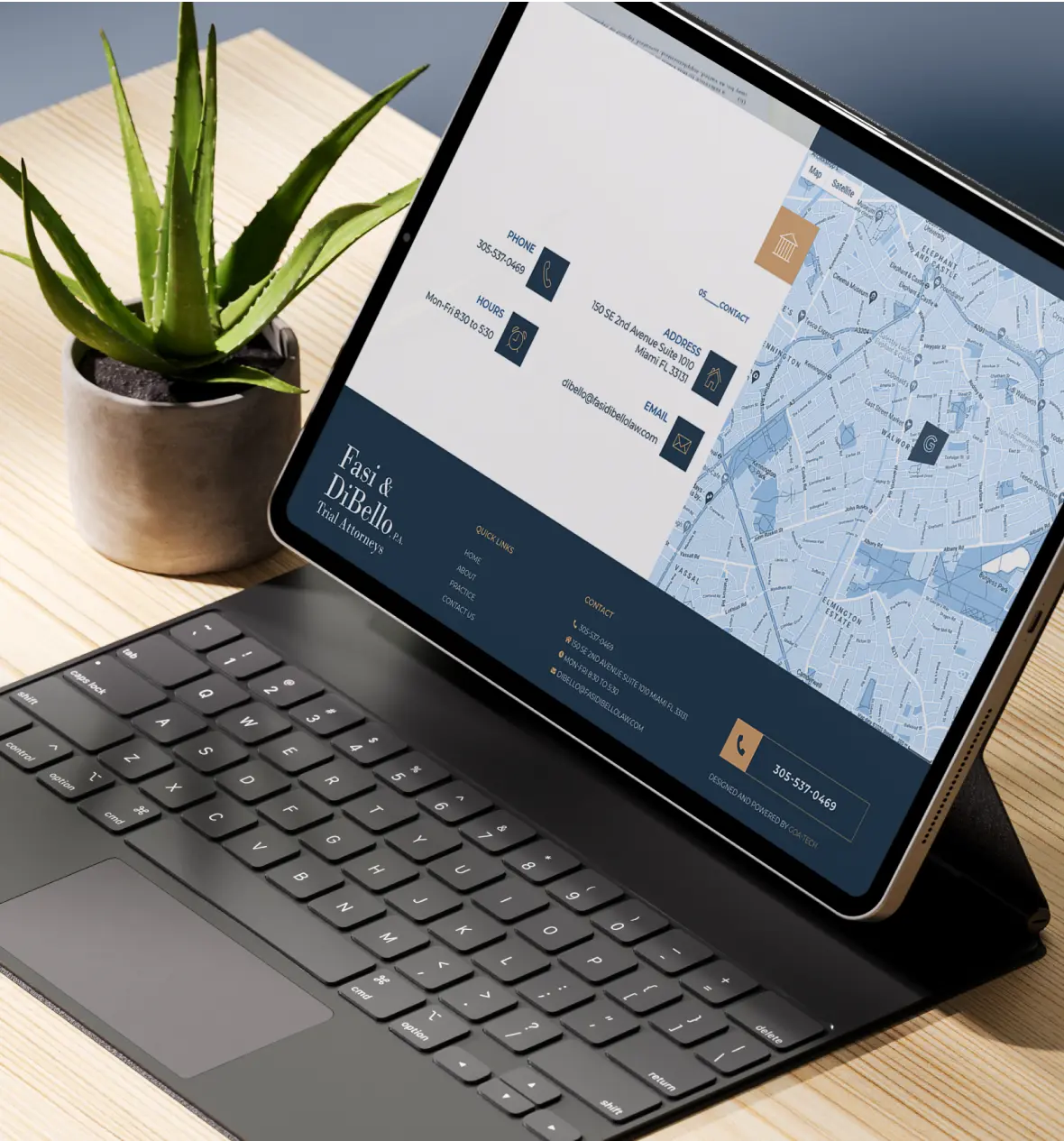 Sleek tablet displaying a digital map next to a potted succulent on a wooden desk.