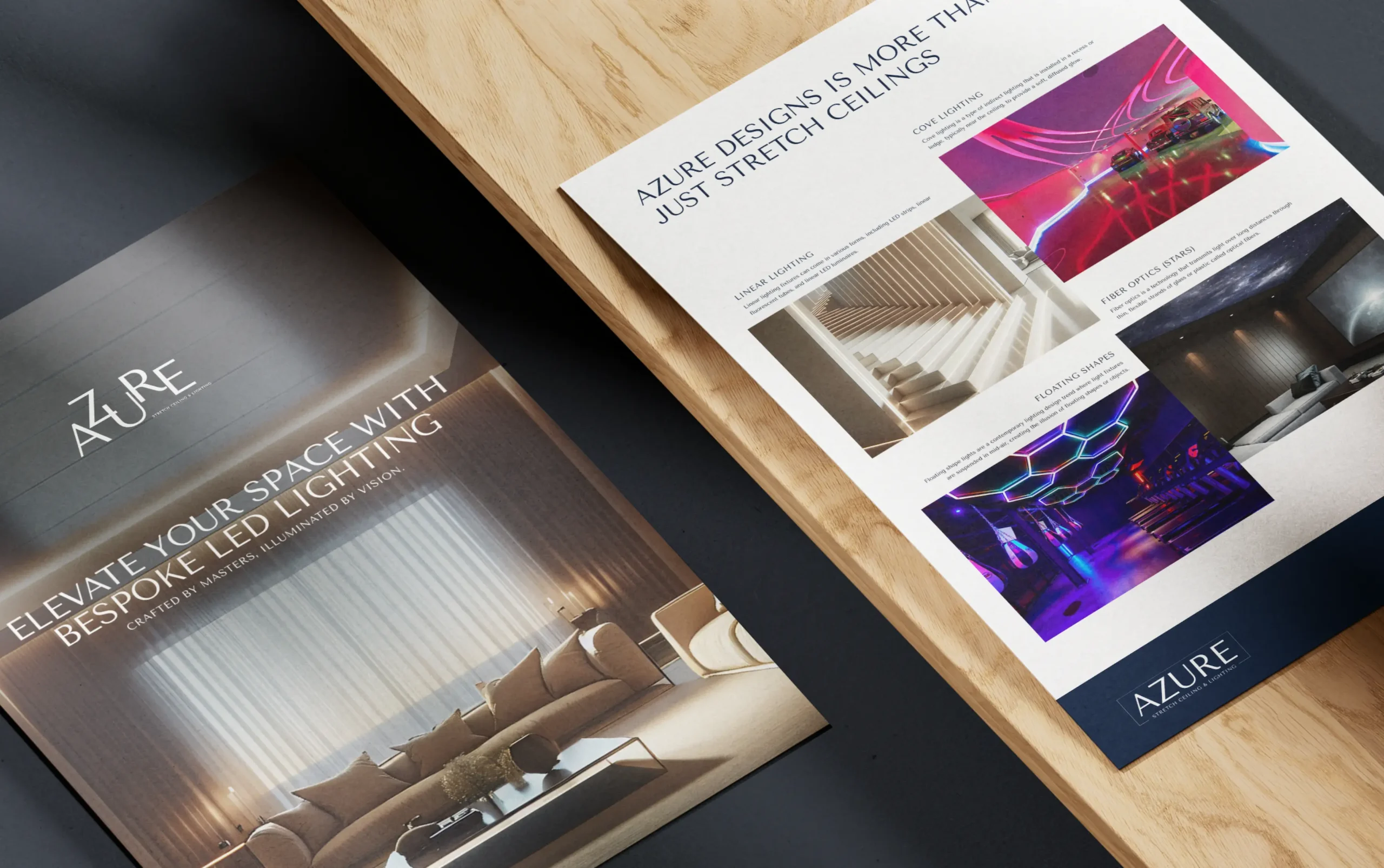 Azure design brochures showcasing luxury interior lighting solutions and elegant layouts on a wooden surface.