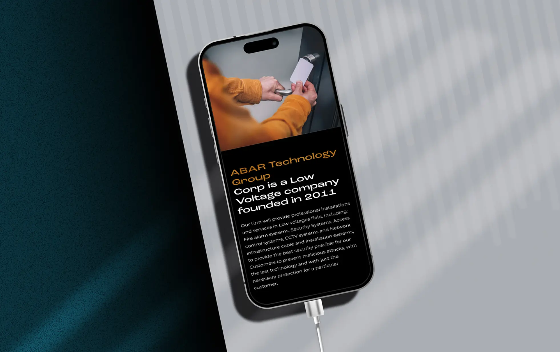 Mobile phone displaying information about ABAR Technology Group with shadow cast on the surface.