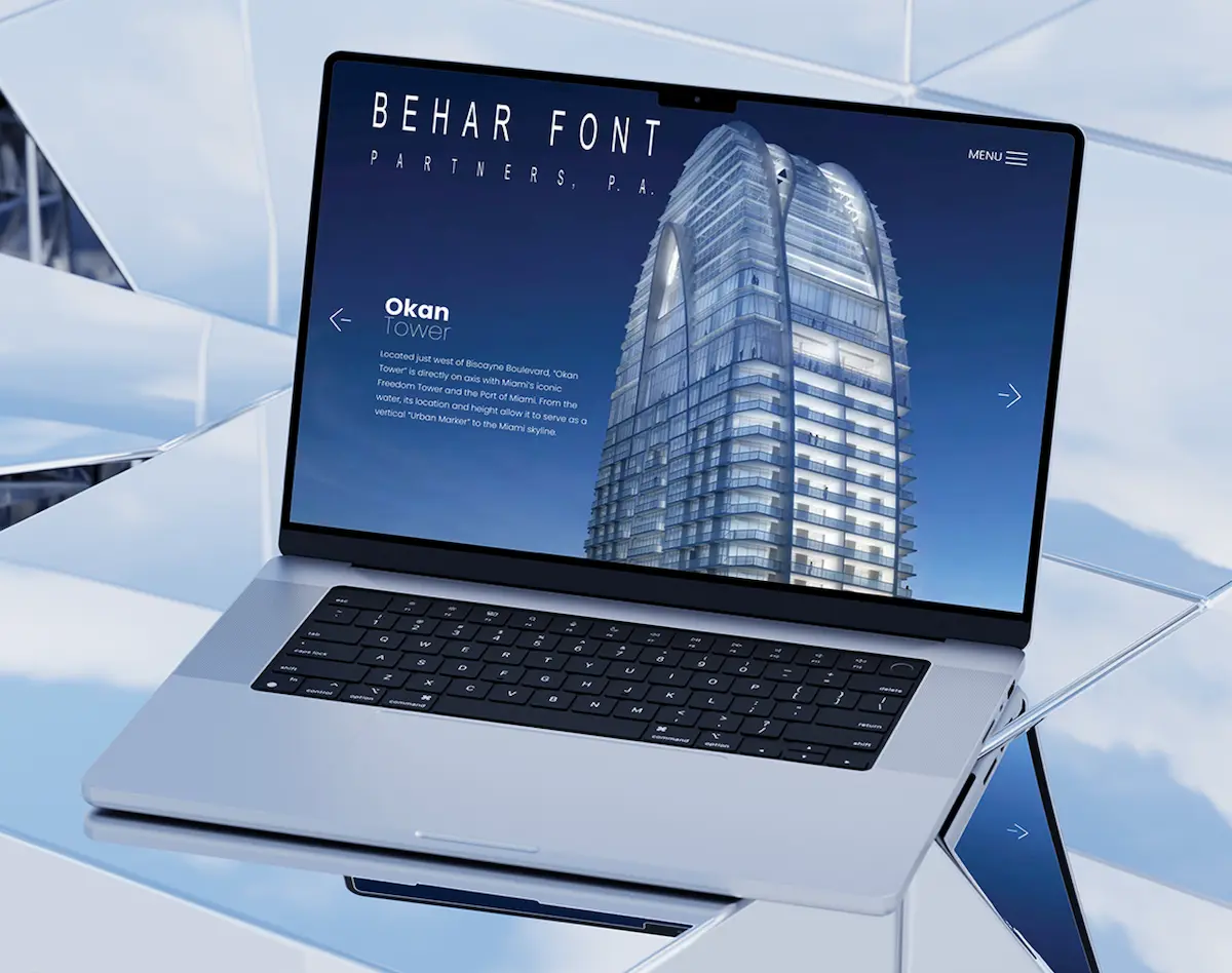 Sleek laptop displaying a modern architectural design against a reflective surface.