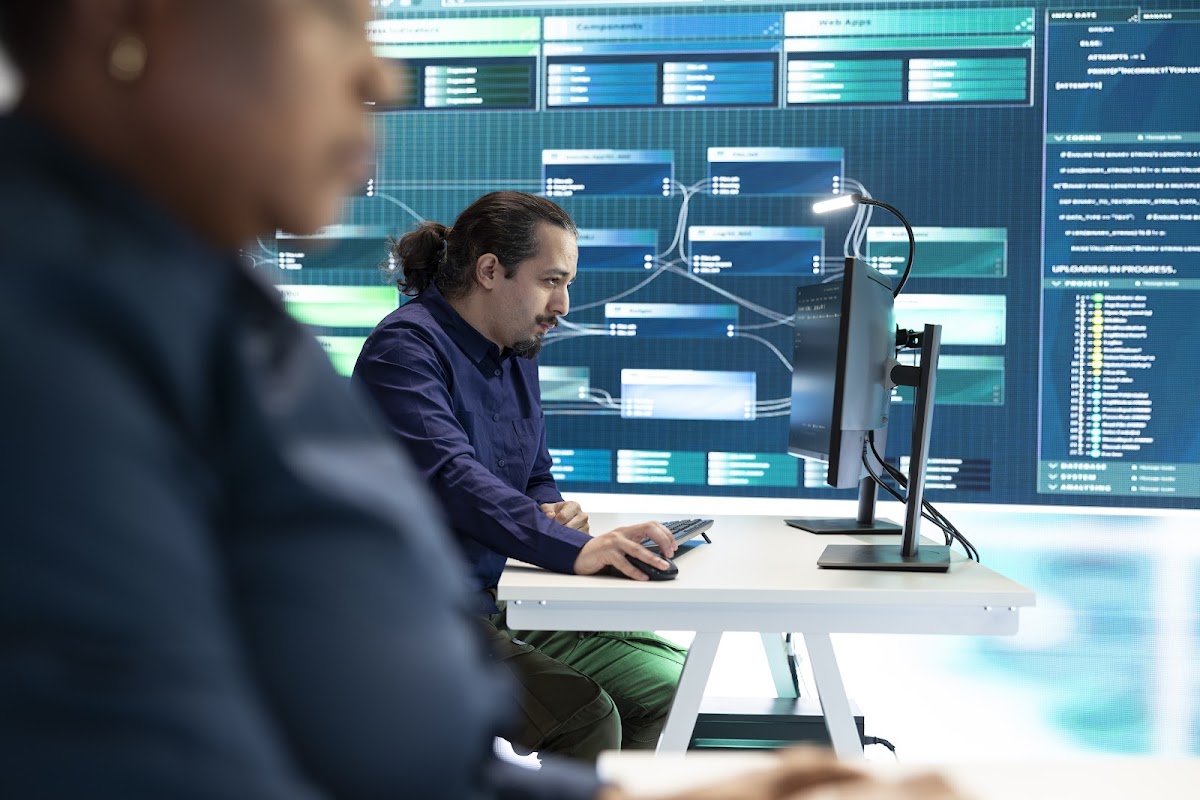 Cybersecurity experts analyzing data on multiple screens in a high-tech control room.