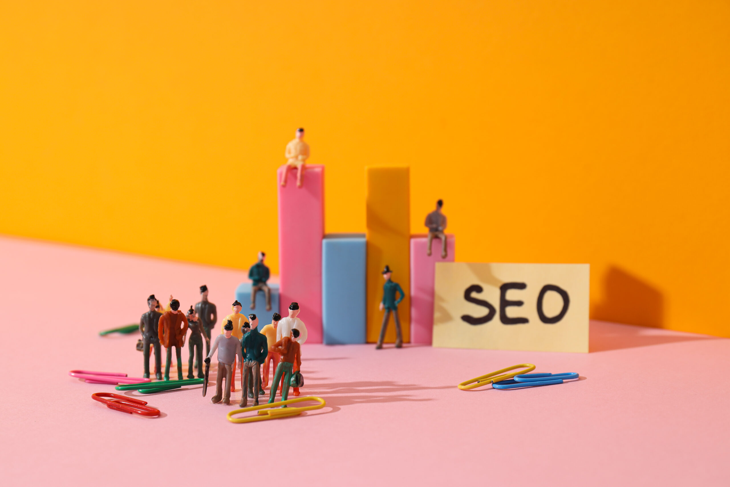 Miniature figures and bar graphs on a desk with 