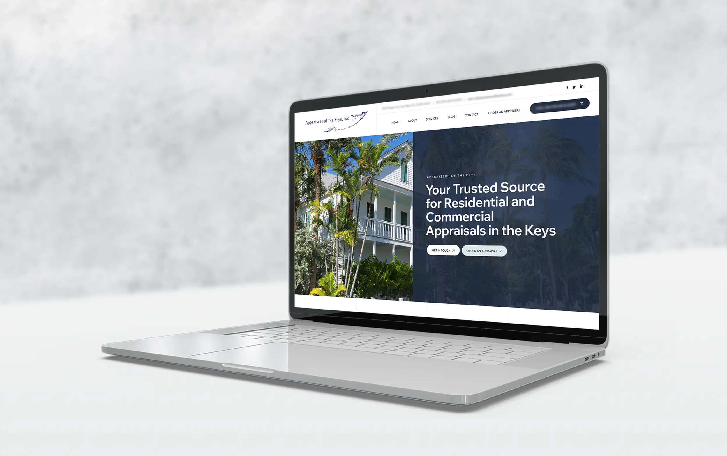 Open laptop displaying a website for residential and commercial appraisals with a Florida Keys theme.