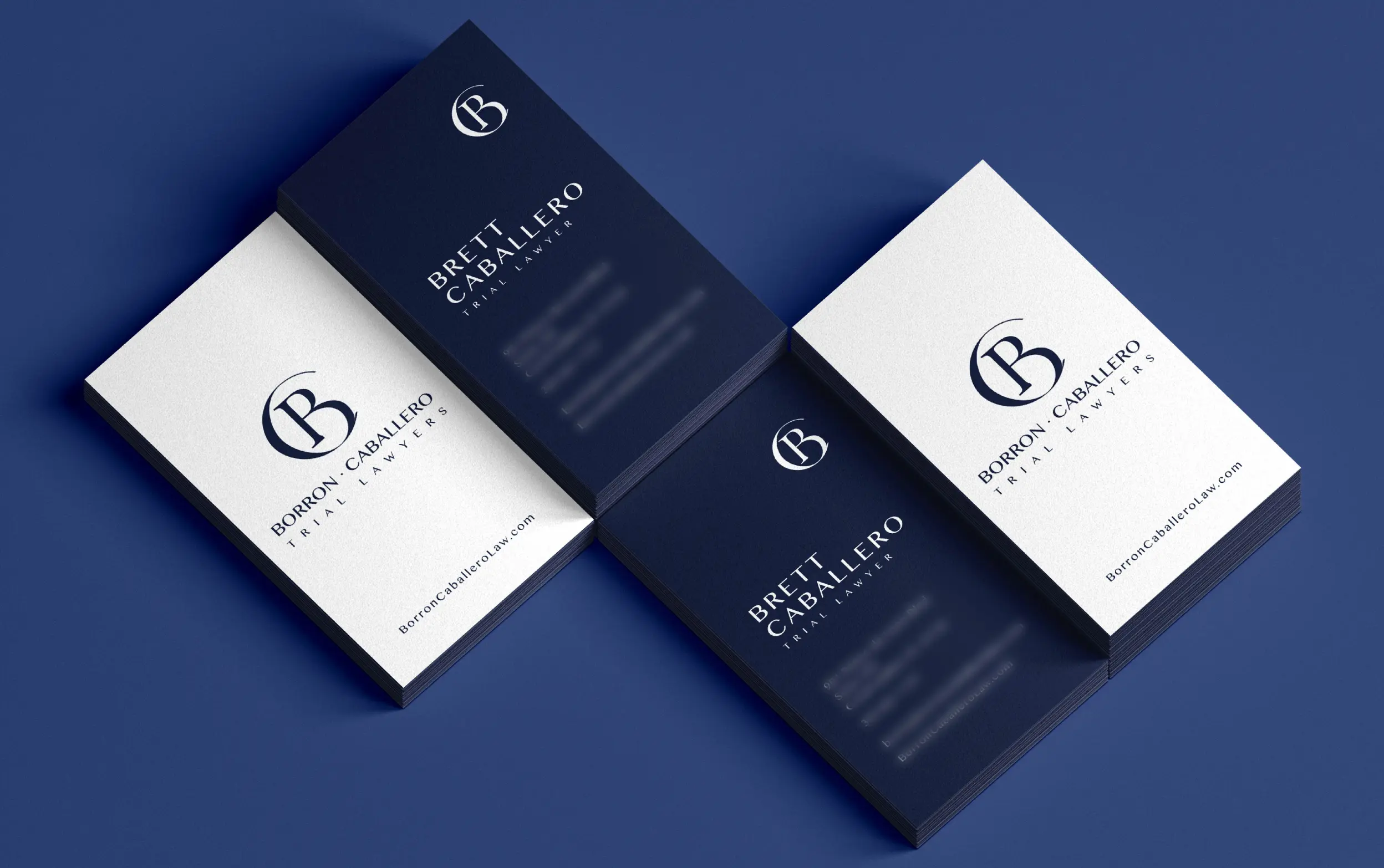 Elegant navy and white business cards with sophisticated design on a blue background.