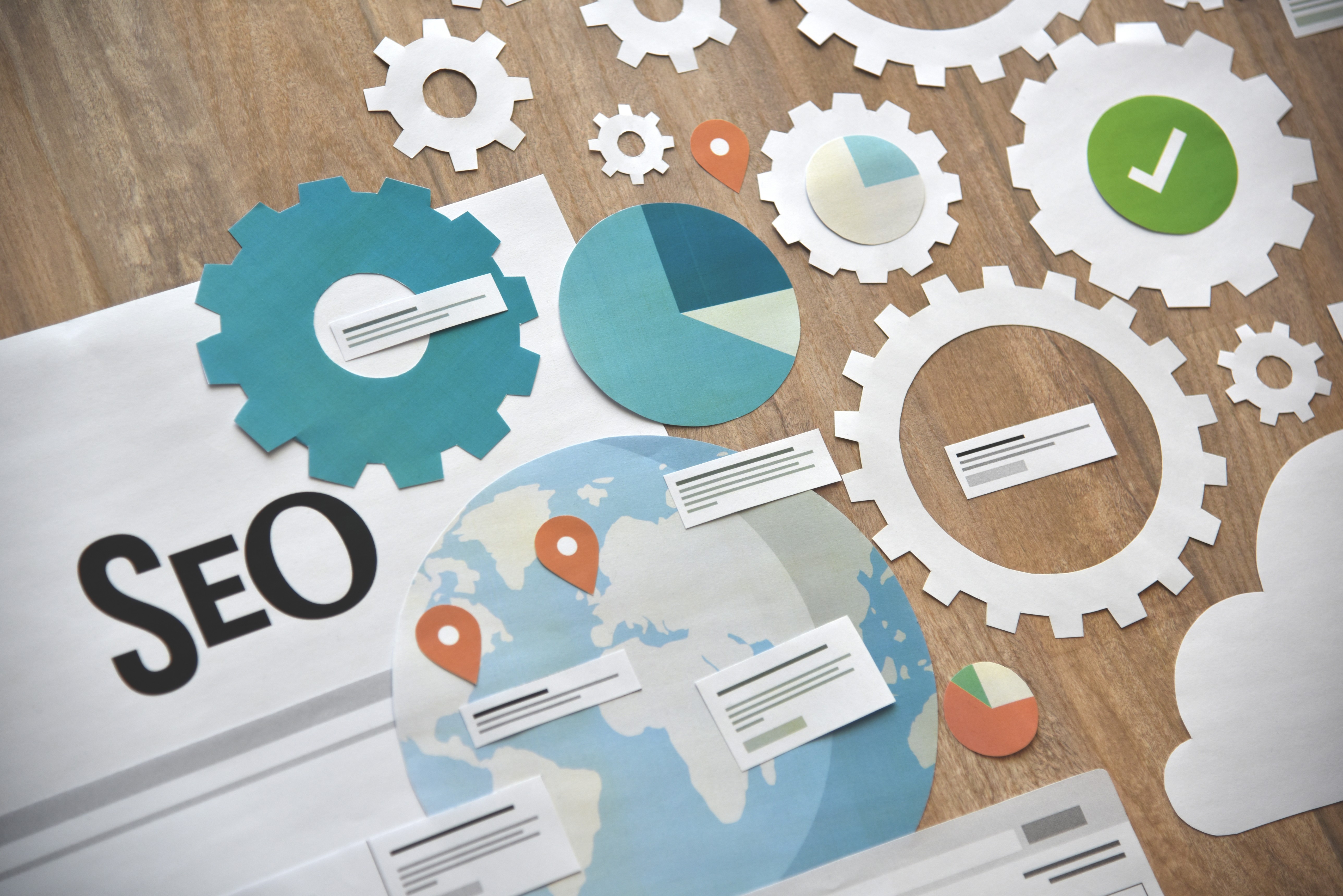 Paper gears and charts illustrating SEO strategy
